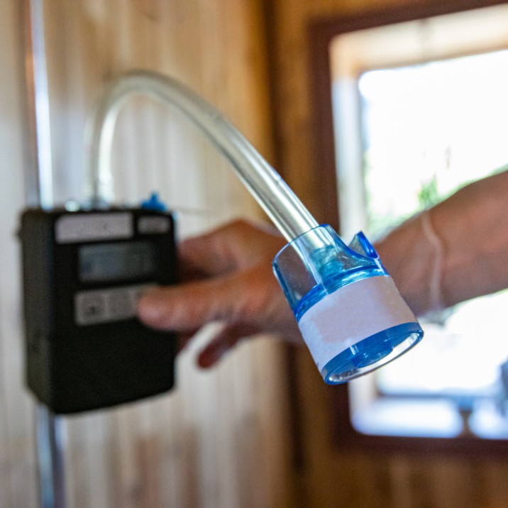 Industrial worker conducting air sampling in Qatar for workplace safety compliance