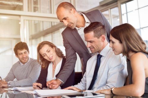 Certified ISO auditor reviewing documentation with a company team in Qatar.