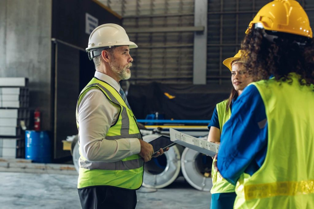 Safety officer inspecting workplace conditions in Qatar for health and safety compliance.