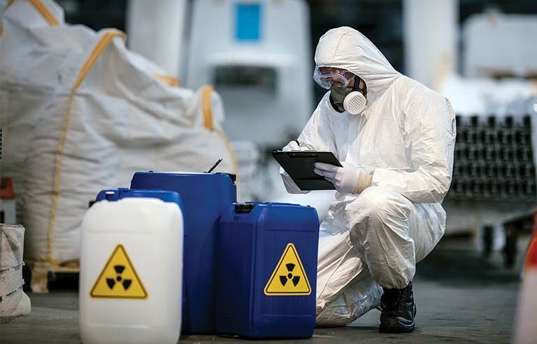 Safety officer conducting chemical risk assessment at an industrial facility in Qatar.