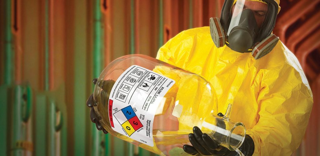 Industrial safety officer evaluating chemical storage in a workplace in Qatar.
