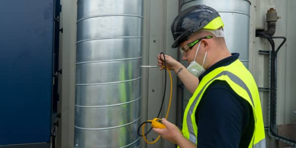 Occupational hygienist inspecting local exhaust ventilation as part of W505 training.