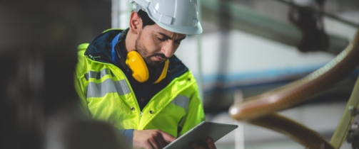 Safety consultant performing HSE risk assessment at workplace in Qatar.