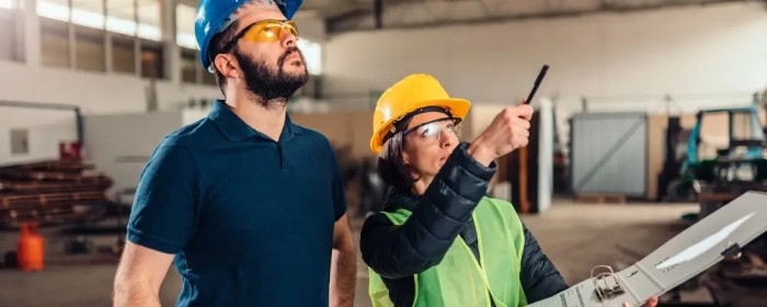 HSE consultant conducting workplace safety inspection in Qatar.
