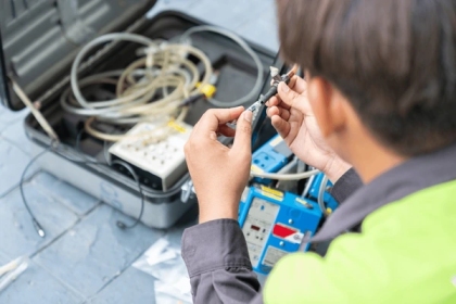 Industrial hygienist performing air contaminant sampling in a Qatar workplace