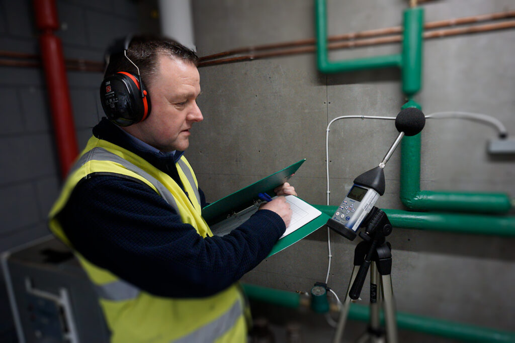 Environmental consultant measuring noise levels for permit compliance in Qatar