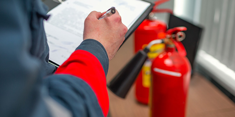 Fire Safety Audit Qatar – Consultant inspecting fire equipment
