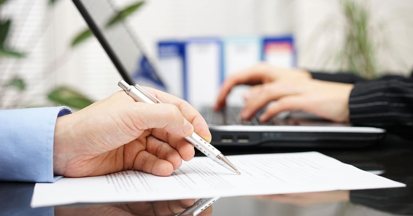 Management system auditor reviewing operational processes during an on-site audit in Qatar