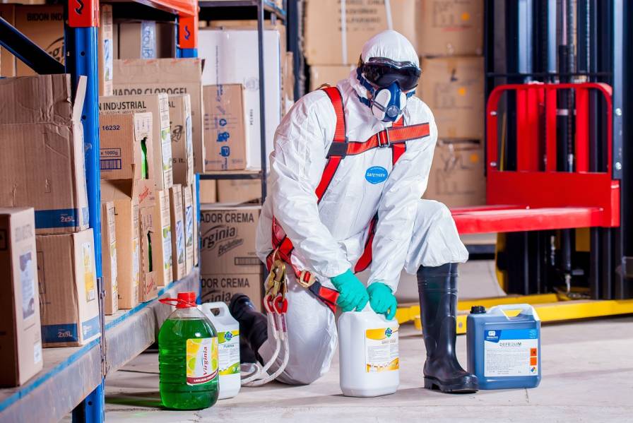 Chemical safety consultant reviewing hazardous substance handling and storage in a workplace